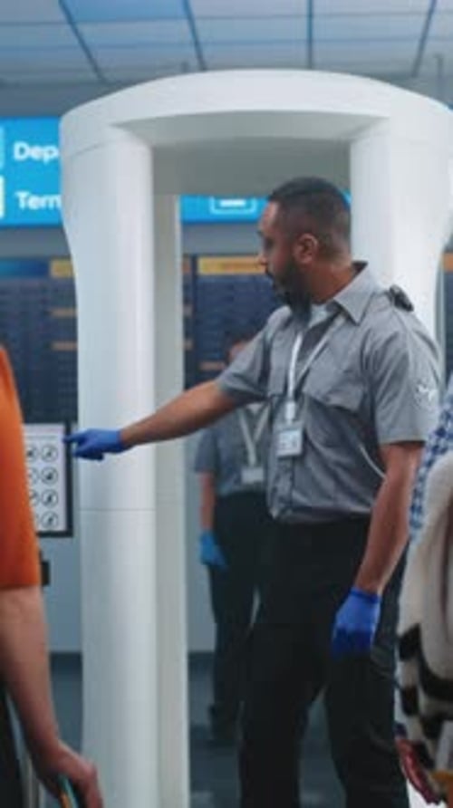 Airport Security Checkpoint Security Officer Instructs People About Metal Detector Scanner Gates