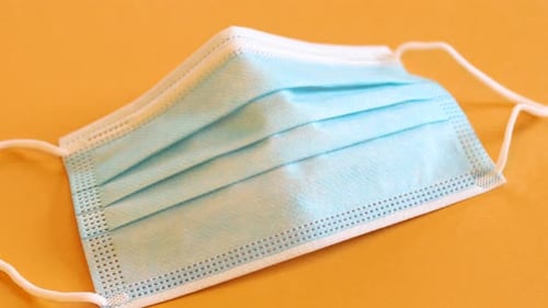 Surgical Face Mask on an Orange Background