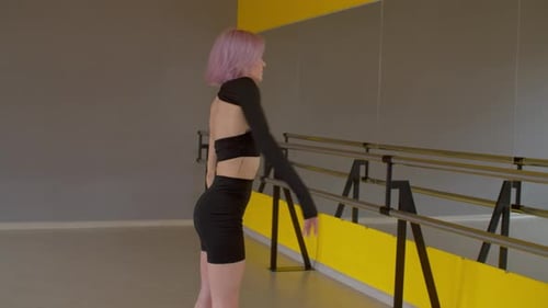 Stylish Woman Dances in Yellow Dance Studio