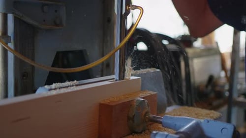 Carpenter in the Workshop Works with Wood Makes Furniture Parts in Natural Light