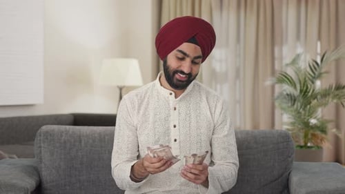 Man Counting Money in Living Room