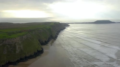 Sea waves breaking over rocks. Waters of the ocean, swirl around the rocky and scenic coastline.