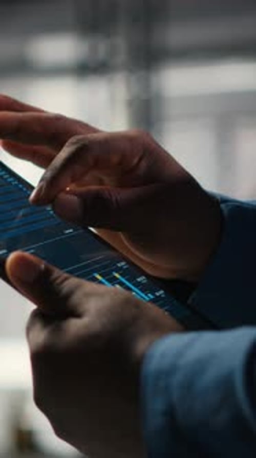 Vertical Video Close Up of Black Employee Engages in Charts Analysis Session on Tablet