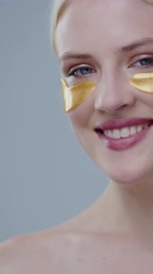 Smiling Woman Wearing Eye Patches Close Up