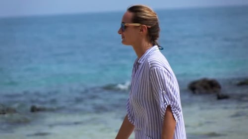 Pretty Young Woman Walking on Beach 240