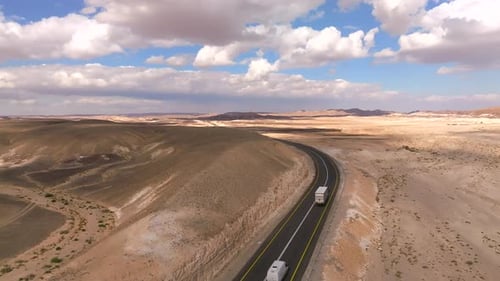 Car on a Desert highway with cloudy blue sky, Aerial view
