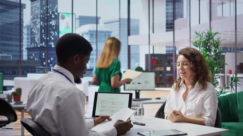 Professional Man and Woman in Modern Urban Office Meeting