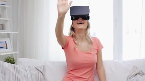 Woman Experiencing Virtual Reality on Couch in Living Room