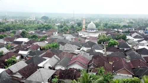 AERIAL 4K Misty Village in Lombok Indonesia with Mosques on Horizon