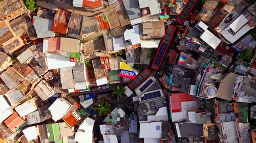 Top down drone view of Comuna 13 in Medellin, Colombia, capturing dense hillside housing, narrow