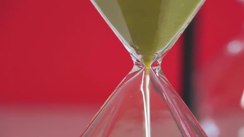 Fantasy background hourglass with sand running through it, measuring the passage of time as gravity