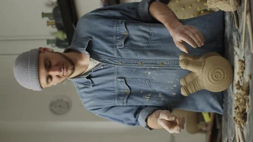 In the Workshop a Male Ceramist Works on Creating Beautiful Ceramic Products