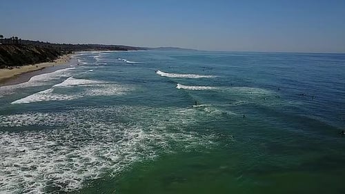 VISTA AÉREA - Surfeando en la playa de Encinitas, California, tiro ancho a la izquierda