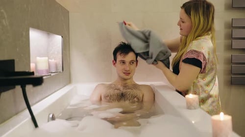 Loving Woman Dries Man's Hair After Bubble Bath