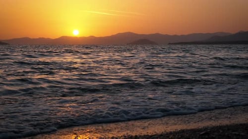 Orange Sun Silhouette By Foaming Night Ocean