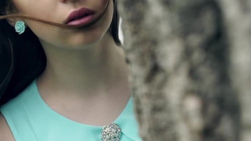 Young Woman Near Tree With Long Brown Hair