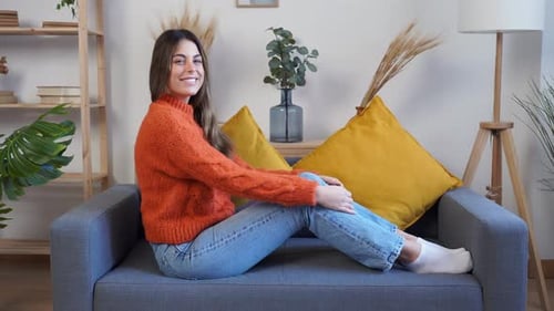 Woman Relaxing on a Couch and Posing