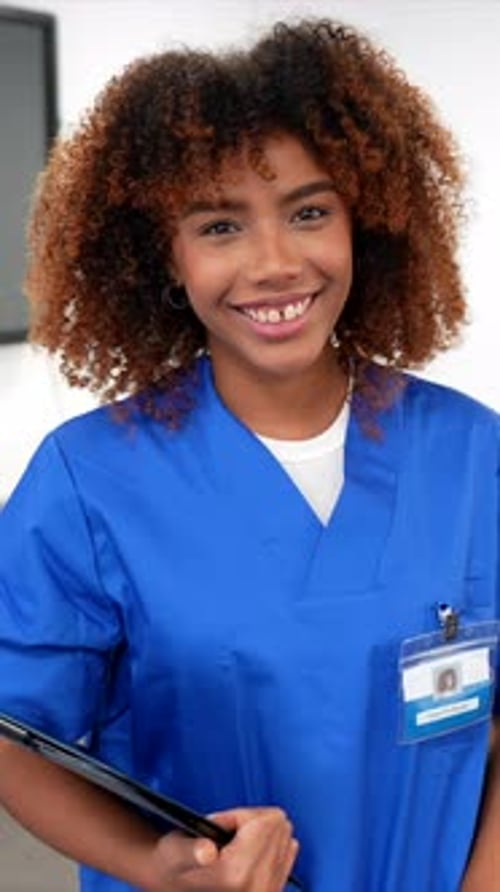 Friendly african american nurse smiling in hospital hallway