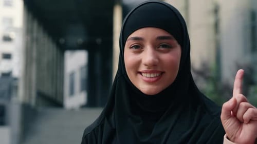 Happy Smiling Muslim Business Woman in Black Hijab City Showing One Finger Idea Portrait Islamic
