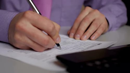 Businessperson Filling Tax Form