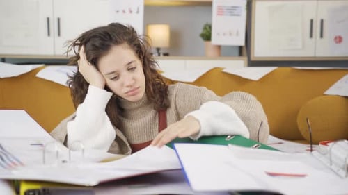 Exhausted Young Woman Working With Files