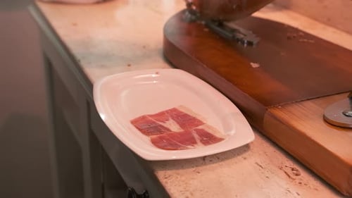 Hand Slices Cured Meat with Fork