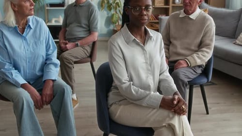 Four People Sitting Patiently in Meeting Room