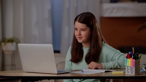 Girl Using Laptop for Online Learning at Home