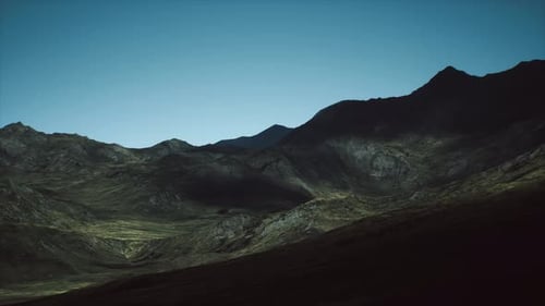 Majestic Mountain Landscape at Dusk with Dramatic Shadows and Soft Light