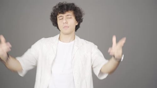 Enthusiastic Young Adult Man Dancing to Music