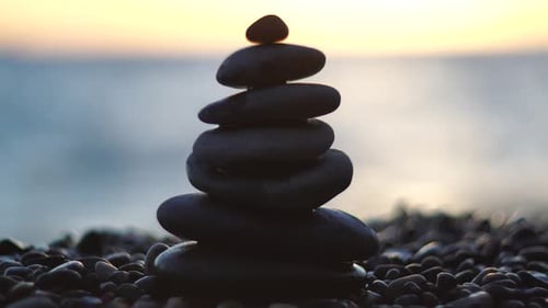 Balanced Rock Pyramid on Pebbles Beach Sunny Day and Clear Sky at Sunset