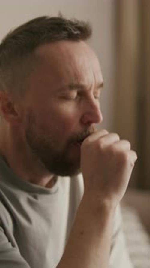 Adult Man Caughing Indoors
