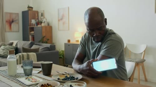 Mature Adult Monitoring Health with Cell Phone