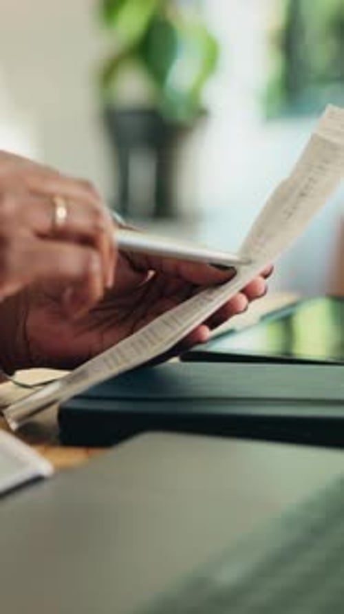 Adult Hand Reviews Financials at Desk Indoors