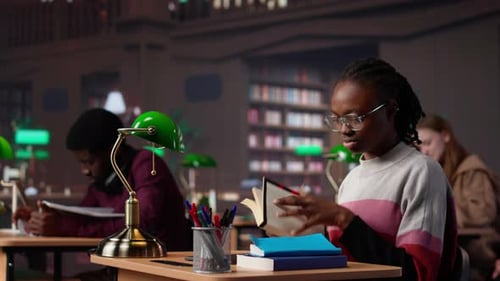Black Girl Focuses on Her Exam Preparations in the Campus Library