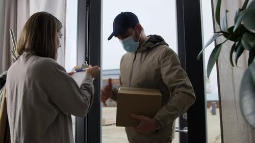 Delivery Man Gives Package to Woman at Door