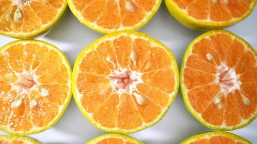 A vibrant close-up showcases fresh half green orange.