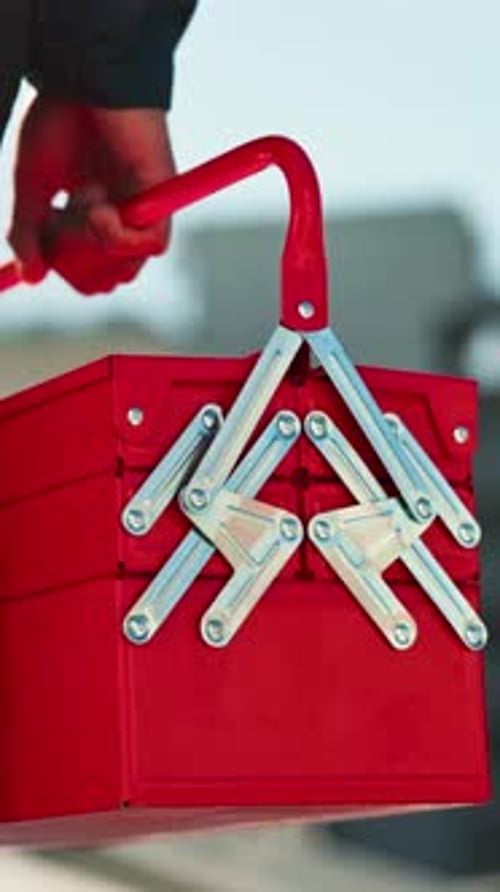 Hand, engineer and person with toolbox for repair, maintenance or inspection in city outdoor