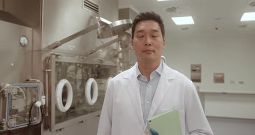 Portrait of Scientist in Corridor Looking at Camera