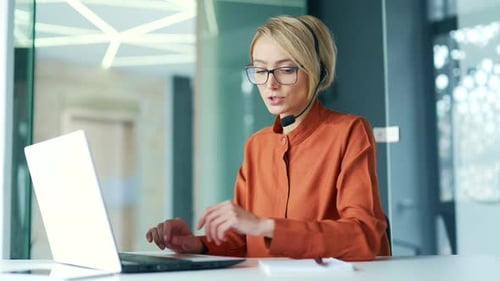 Сorporate operator who works in the support service speaks on a video call using a laptop. Сall cent