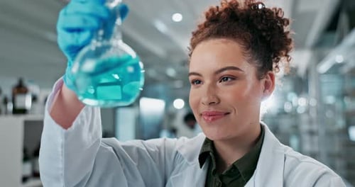 Scientist Observes Blue Liquid in Flask in Lab
