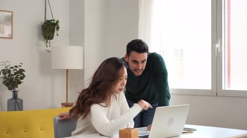 Man and Woman Working Together on Laptop Indoors