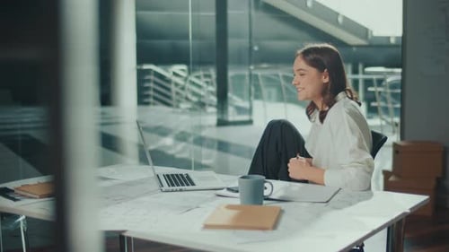 Female Architect Working in a Office at a Laptop Making a Video Call
