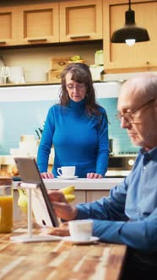 Couple Using Tablet During Morning Breakfast at Home