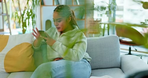 Happy woman, phone and laughing on a sofa at funny meme, post or joke in a living room