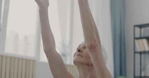 Senior Woman Practicing Yoga at Home