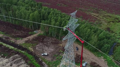 Construction Workers Repairing Overhead Power Lines in Forest