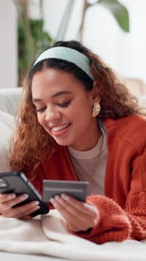 Smiling Woman Shopping Online Using Phone and Credit Card