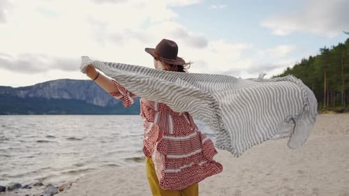 Woman With Scarf Enjoying Scenic Beach