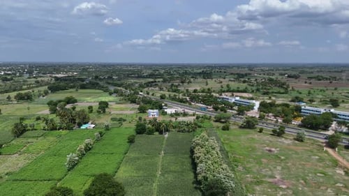 Aerial view of vehicles navigating an Indian highway amidst scenic surroundings